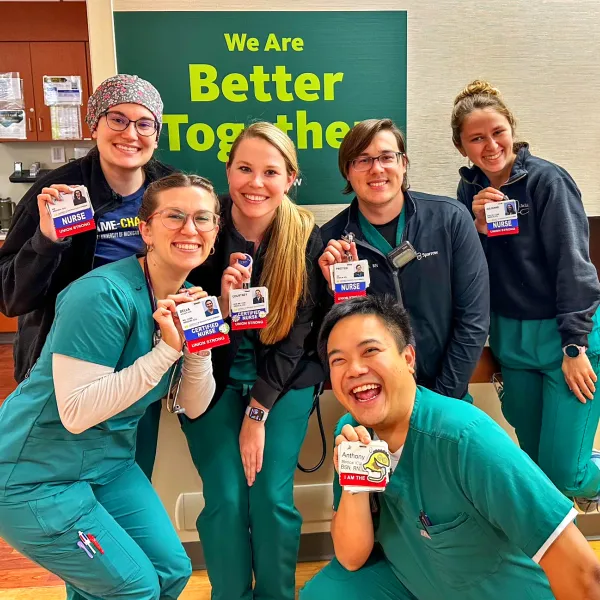 Group of nurses holding badges